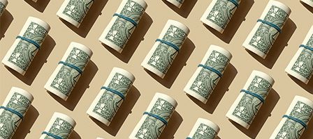 Neatly arranged dollar bills in rows