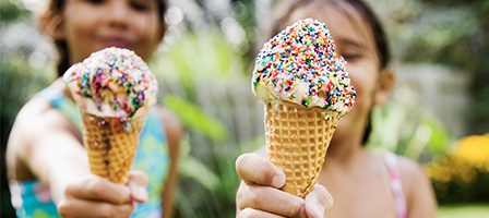 Two ice cream cones with rainbow sprinkles