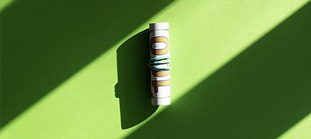 Currency roll with sunlight shadows