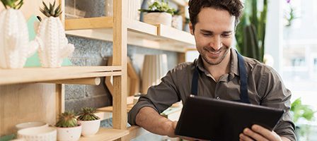 Man using tablet in plant shop