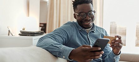 Relaxed man shopping online on phone