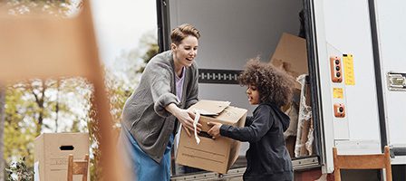 Parent and child with cardboard boxes