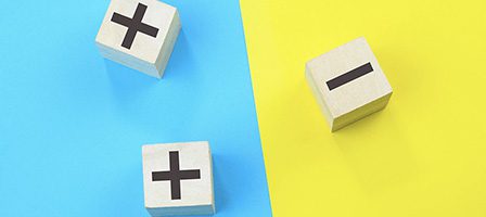 Wooden blocks with plus and minus symbols