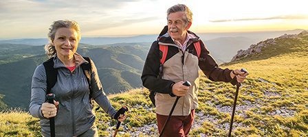Senior couple hiking with trekking poles