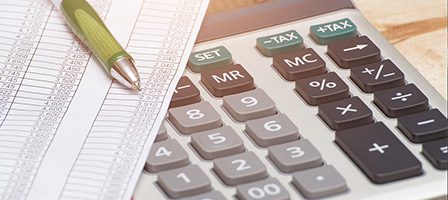 Financial spreadsheet with calculator and pen