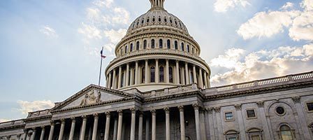 Historic Capitol dome with clouds above