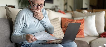 Senior using laptop at home