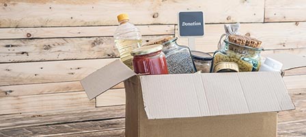 Cardboard box with various food donations.