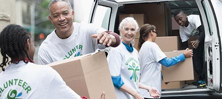 Volunteers unloading boxes from a van