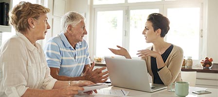 Elderly couple consulting with professional advisor
