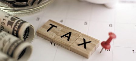 Tax blocks on calendar with money