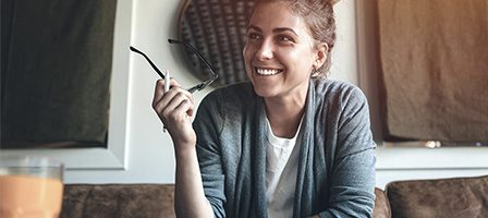 Relaxed woman sitting with glasses