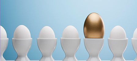 Golden egg among white eggs