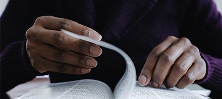 Hands turning pages of a book