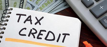 Tax credit notebook with money and calculator