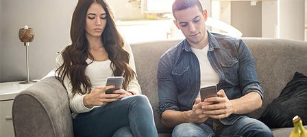 Two people focused on their phones