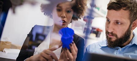 Professionals analyzing a 3D printed design.
