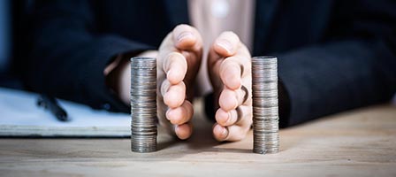 Businessman separating coin stacks
