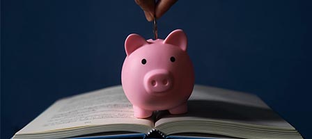 Piggy bank on open book