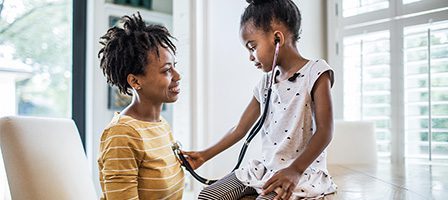 Young girl listening to woman's heartbeat