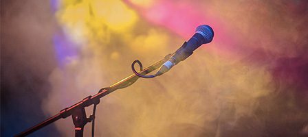 Microphone in smoky, colorful concert scene