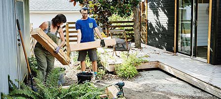 Two people building a garden deck